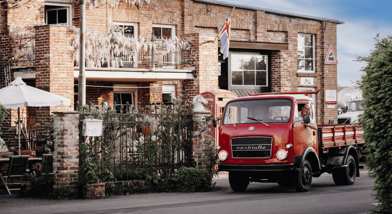 Ein Bild der Veteranenhalle mit historischen LKW's davor.